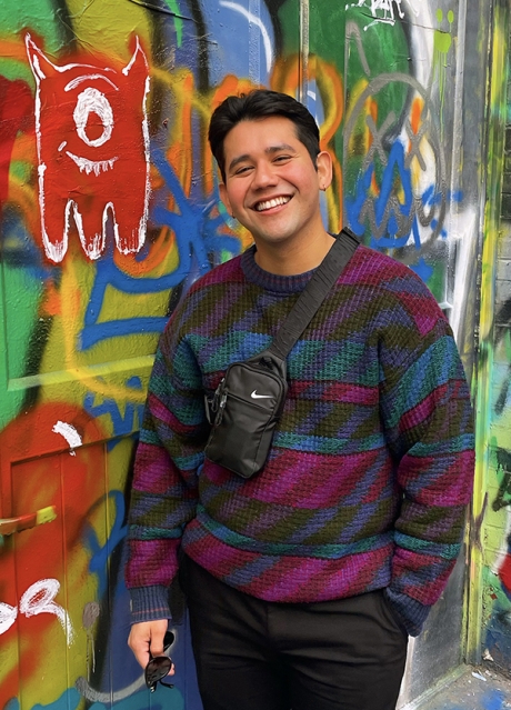 Health Equity Scholar and PhD student Michael Ramirez stands in Baltimore's Graffiti Alley. Michael Ramirez is a Health Equity Scholar PhD student