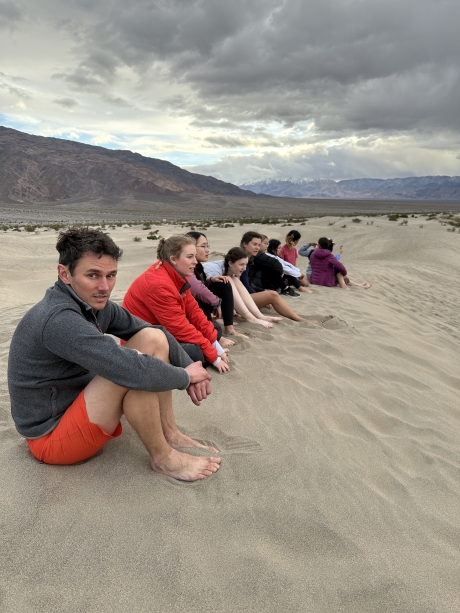 people outdoors sitting in sand