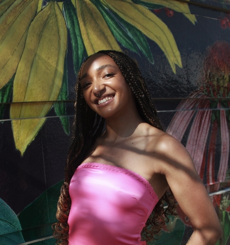 Mackenna Lindsay Mackenna Lindsay stands in front of a mural