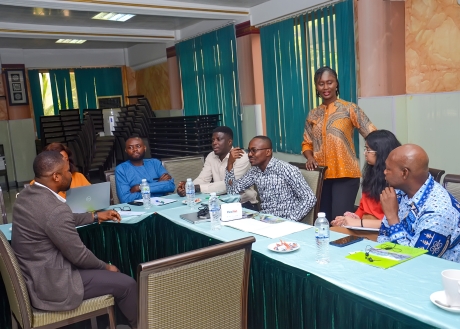 7-8 people around a table having a discussion 