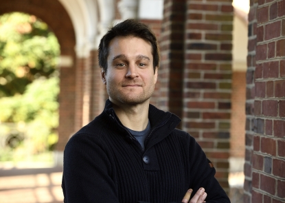 Ruggero Rossi, EHE Assistant Professor male faculty standing outside college campus