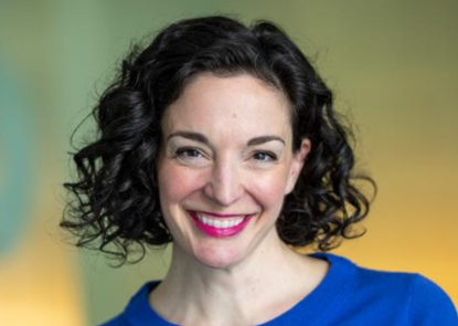 Diane Coraggio, white woman with dark hair wearing a blue sweater