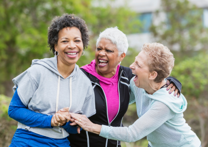 Three people laughing and embracing