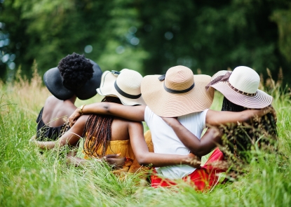 Four black women in a field 