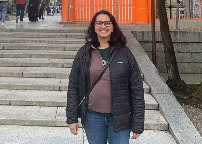 woman stands in front of steps