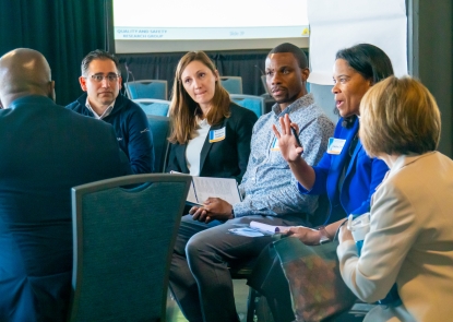 Participants gather in small groups 