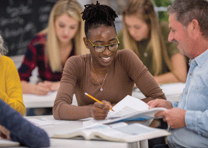 Black woman learning in a classroom