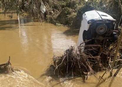 photo of overturned van in water