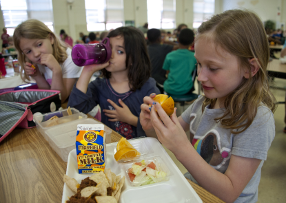 School children eating lunch in a cafeteria 